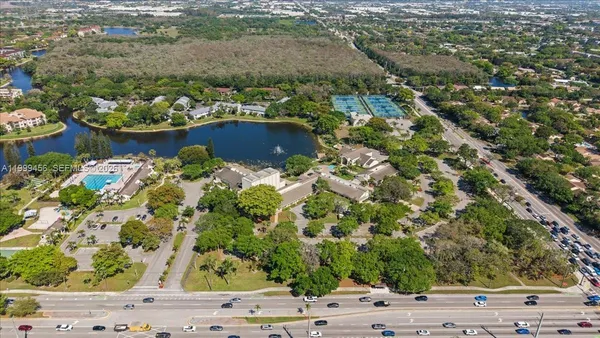 an aerial view of house with yard swimming pool and outdoor seating