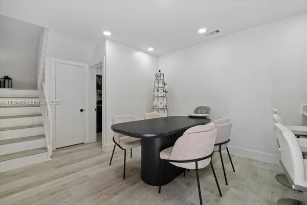 a view of a dining room with furniture and wooden floor