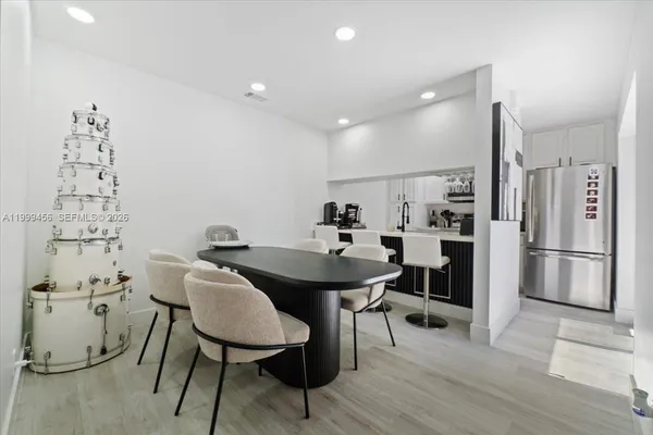 a kitchen with stainless steel appliances kitchen island hardwood floor and breakfast area