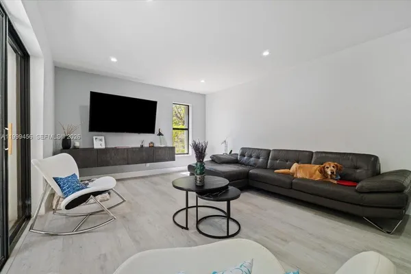 a living room with furniture and a flat screen tv