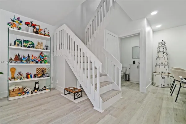 a view of entryway with lots of stuff and hardwood floor