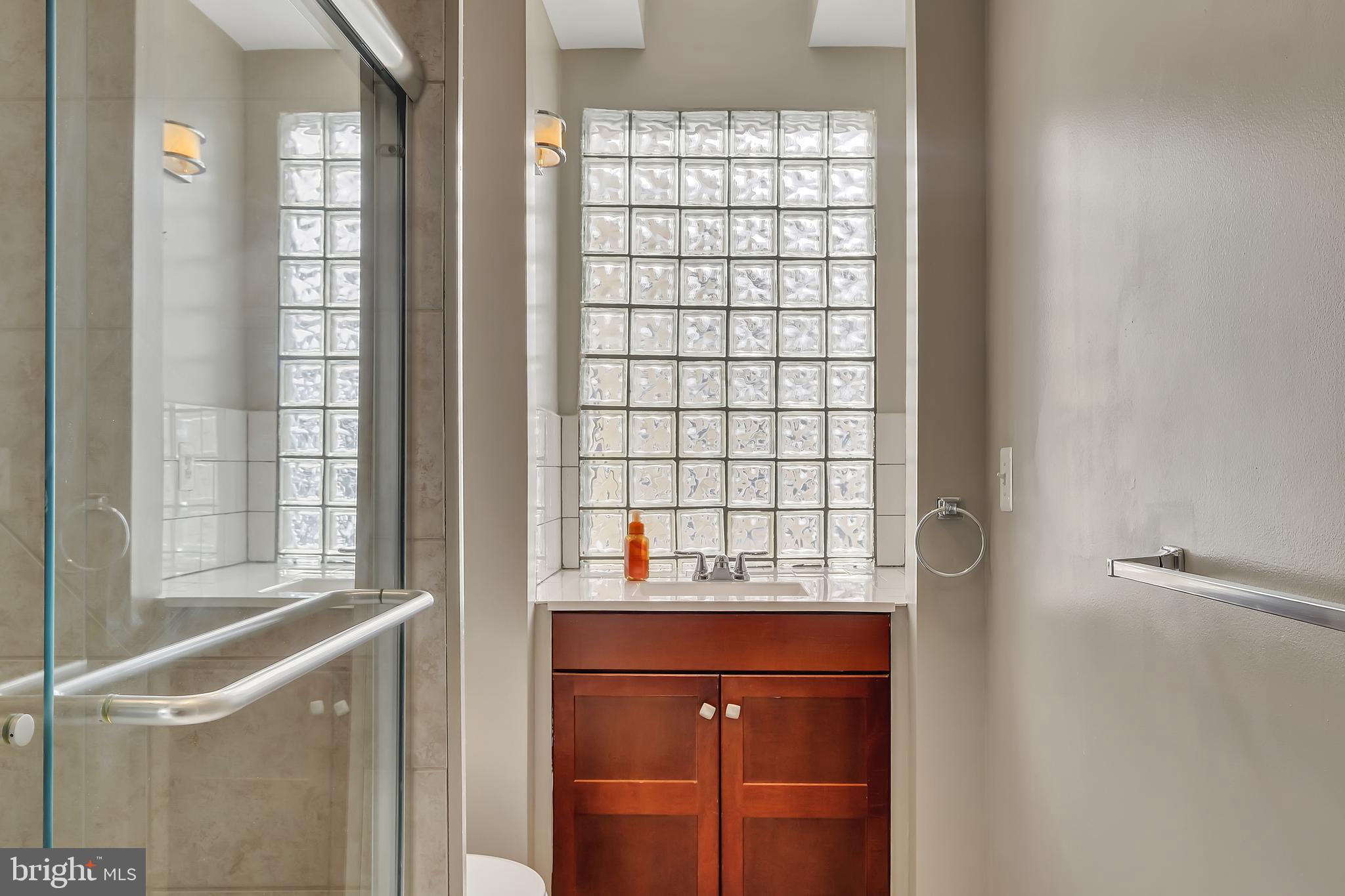 3504 Edgewood Road Baltimore, MD 21215 - Photo 21 of 60 a bathroom with a sink and a window