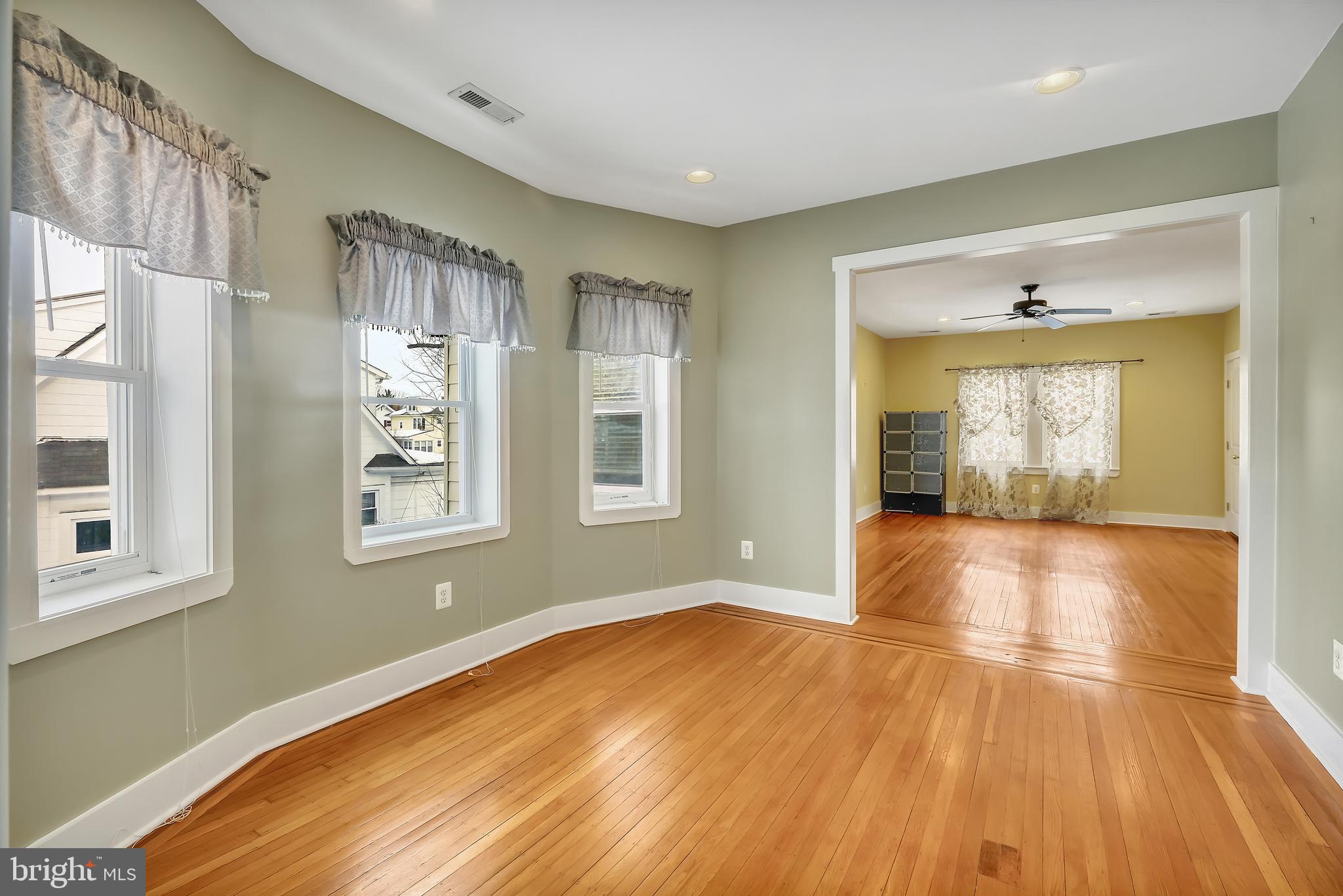 3504 Edgewood Road Baltimore, MD 21215 - Photo 30 of 60 a view of empty room with wooden floor and fan