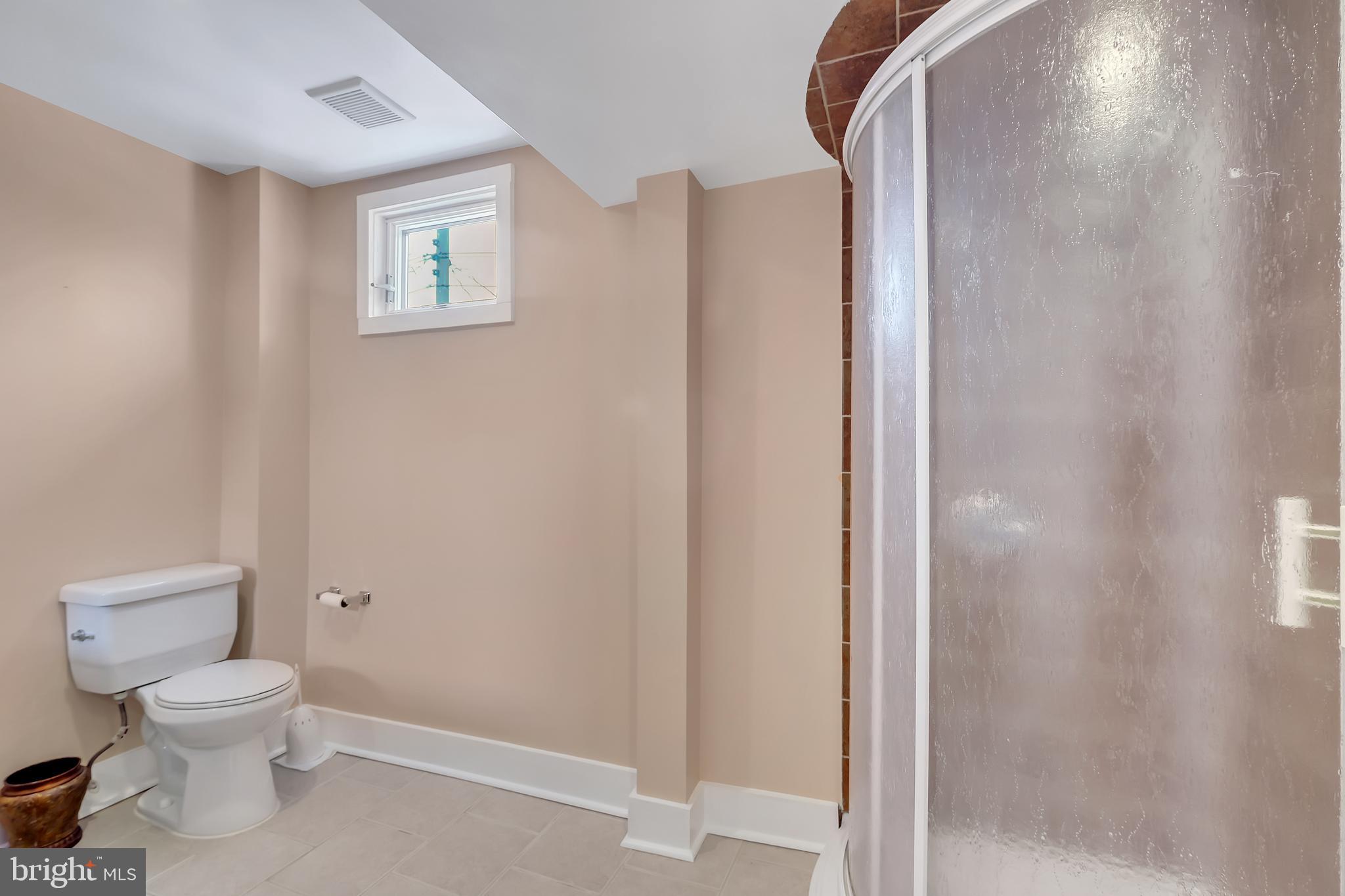 3504 Edgewood Road Baltimore, MD 21215 - Photo 37 of 60 a white toilet sitting next to a bathroom sink