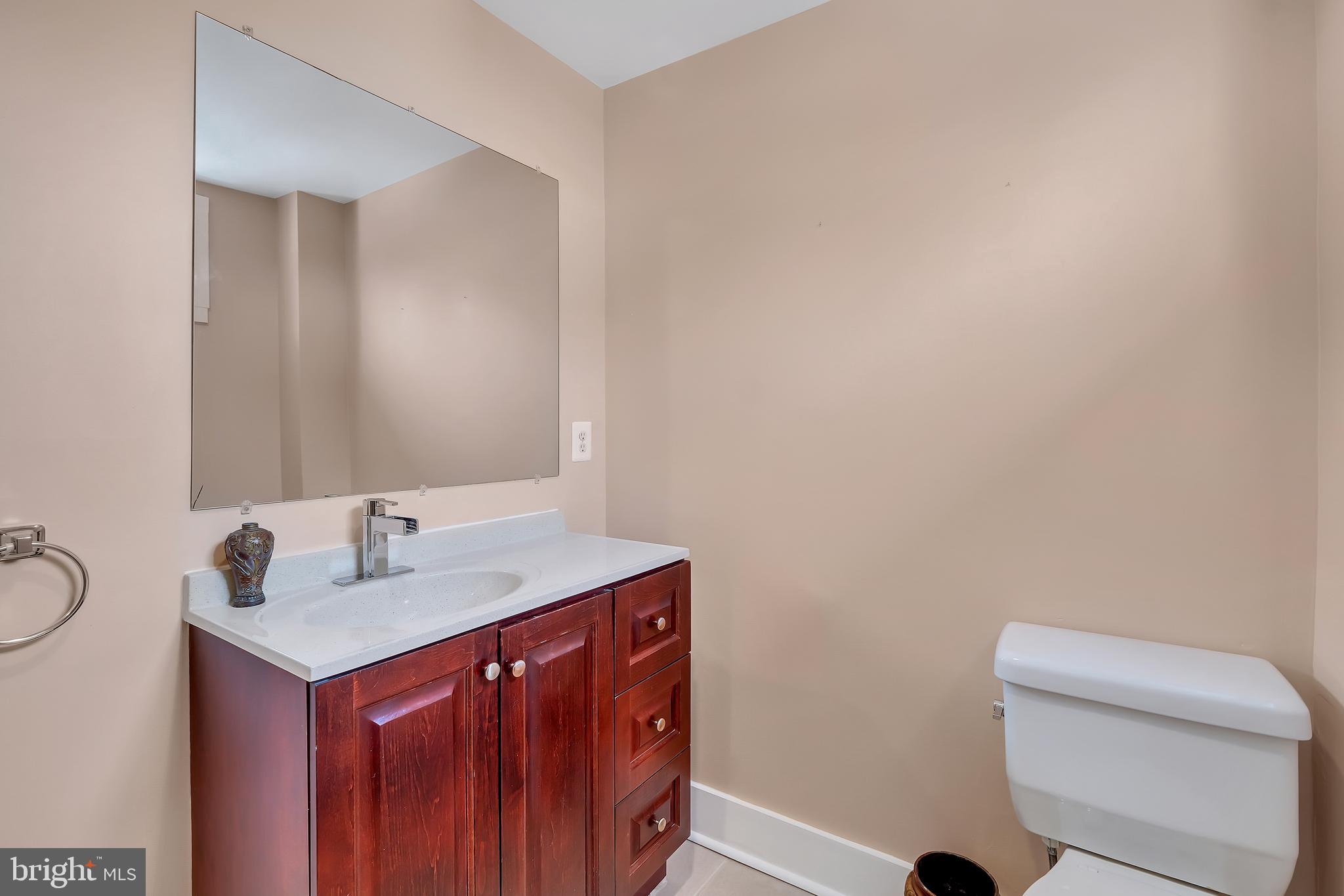 3504 Edgewood Road Baltimore, MD 21215 - Photo 38 of 60 a bathroom with a sink vanity and toilet