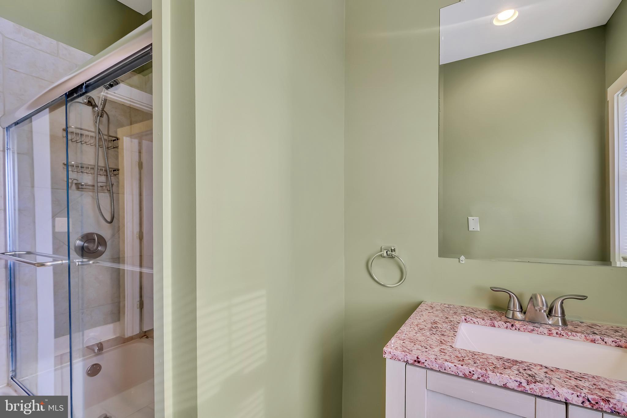 3504 Edgewood Road Baltimore, MD 21215 - Photo 42 of 60 a bathroom with a granite countertop sink and a mirror