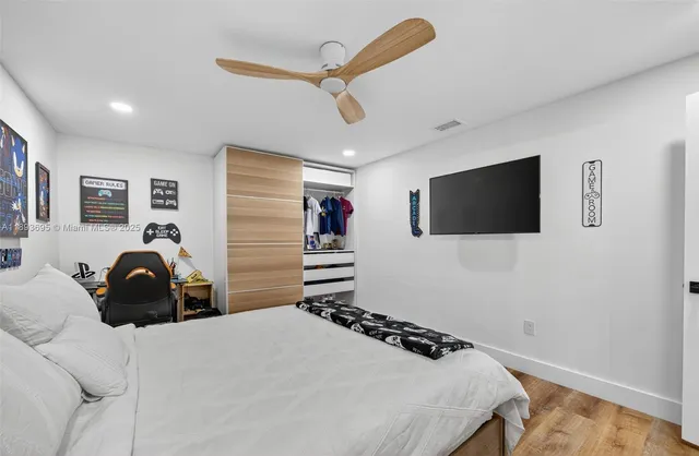 a bedroom with a bed and a flat screen tv