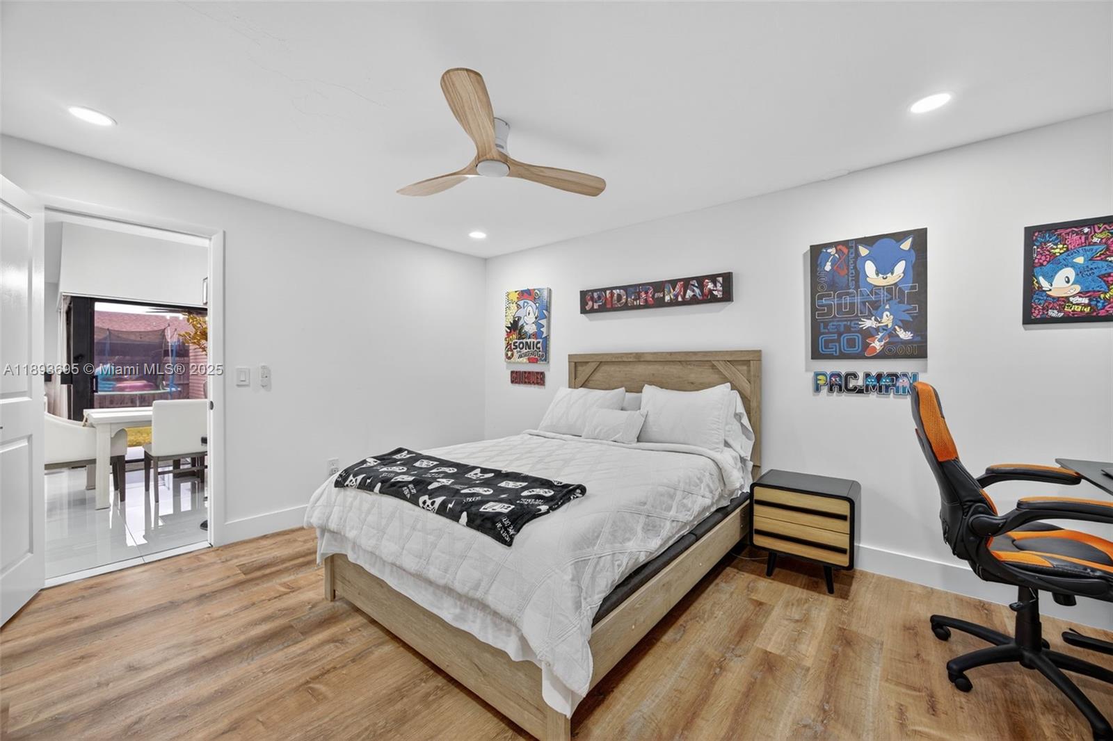 25796 Southwest 123rd Avenue Homestead, FL 33032 - Photo 12 of 26 a bedroom with a bed and dresser with wooden floor