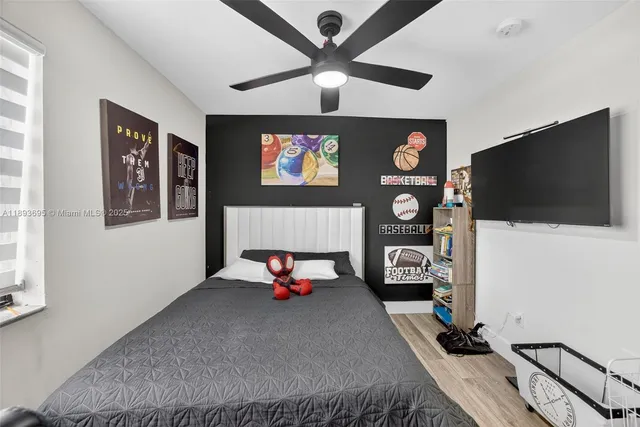 a bedroom with furniture and a flat screen tv