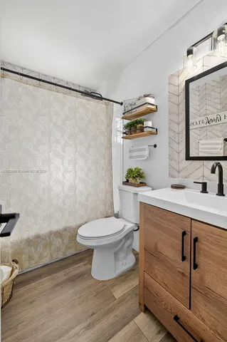 a bathroom with a sink toilet and shower