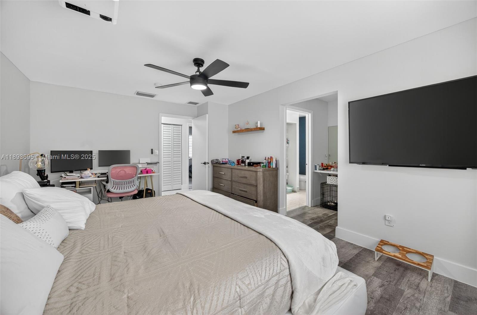 25796 Southwest 123rd Avenue Homestead, FL 33032 - Photo 20 of 26 a bedroom with a bed and a flat screen tv