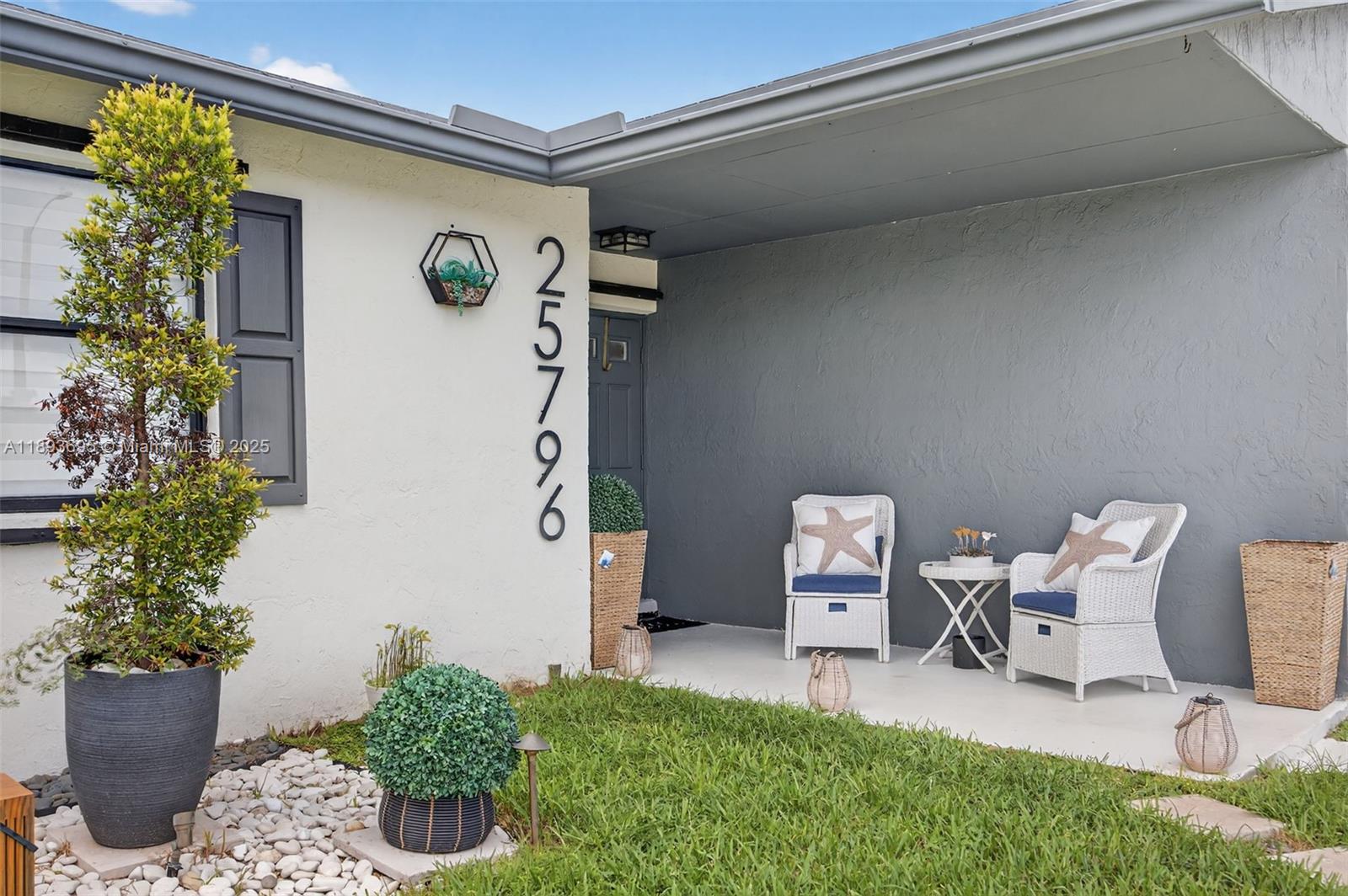 25796 Southwest 123rd Avenue Homestead, FL 33032 - Photo 2 of 26 a front view of a house with entryway
