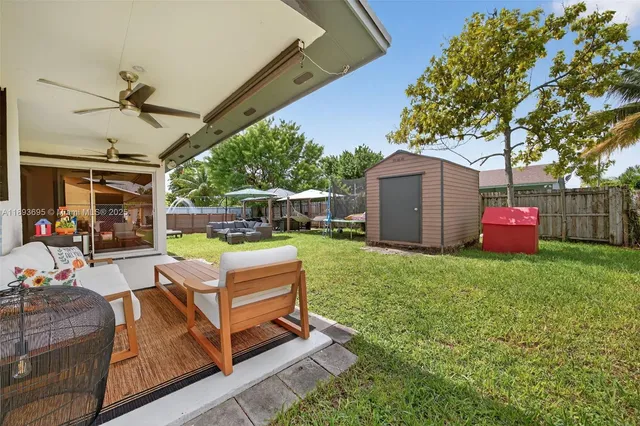 a backyard of a house with table and chairs