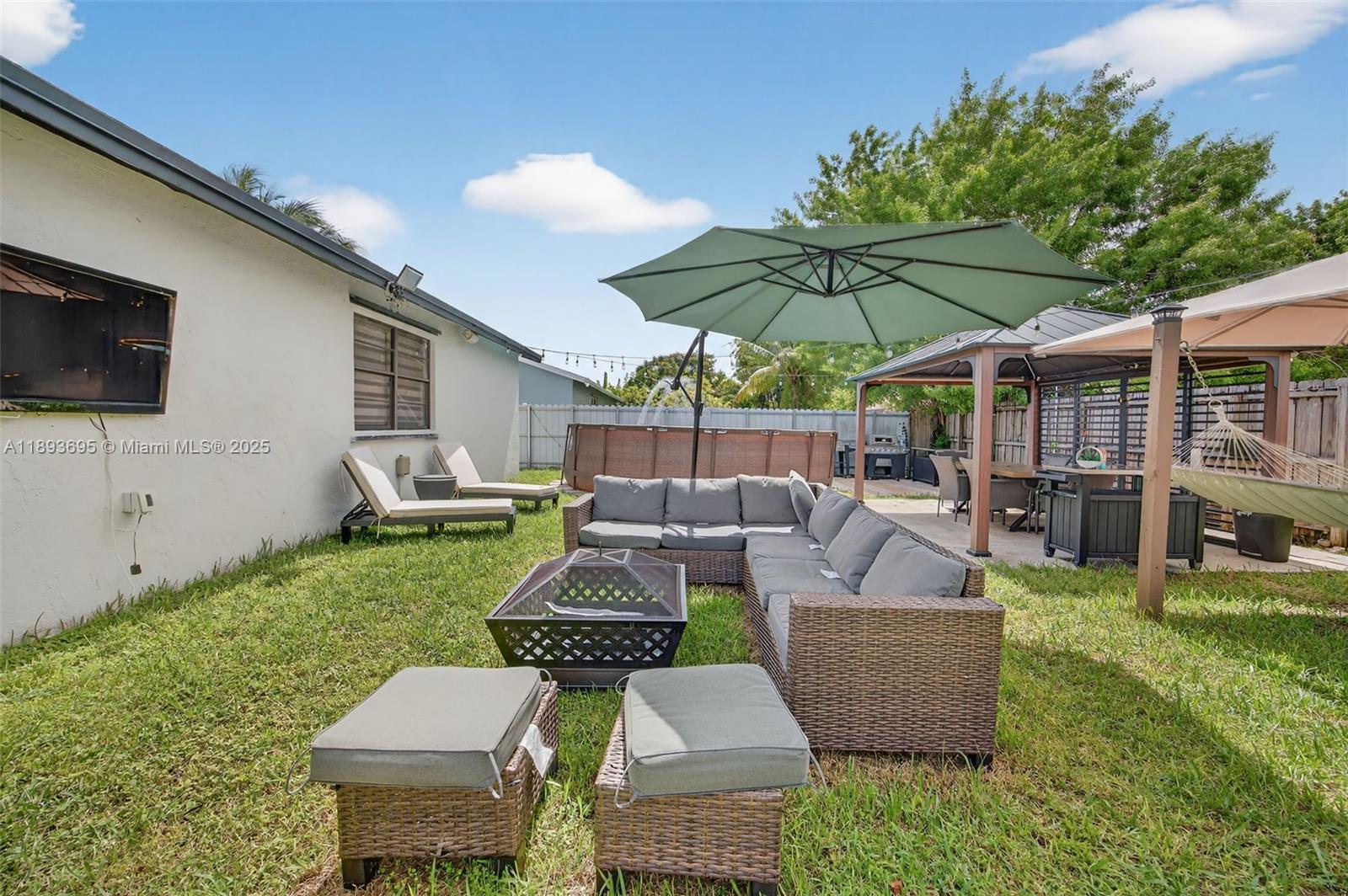 25796 Southwest 123rd Avenue Homestead, FL 33032 - Photo 25 of 26 a view of a patio with couches chairs and a big yard