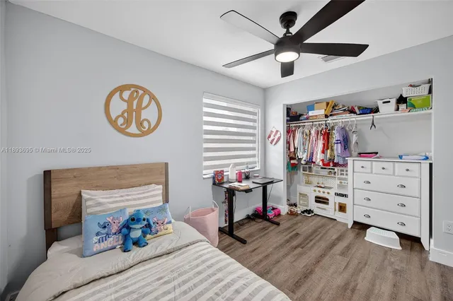 a bed room with a bed and a chair