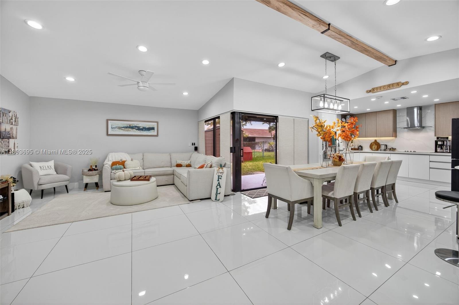 25796 Southwest 123rd Avenue Homestead, FL 33032 - Photo 3 of 26 a living room with furniture a dining table and kitchen view
