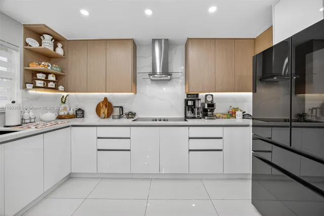 a kitchen with a refrigerator and cabinets