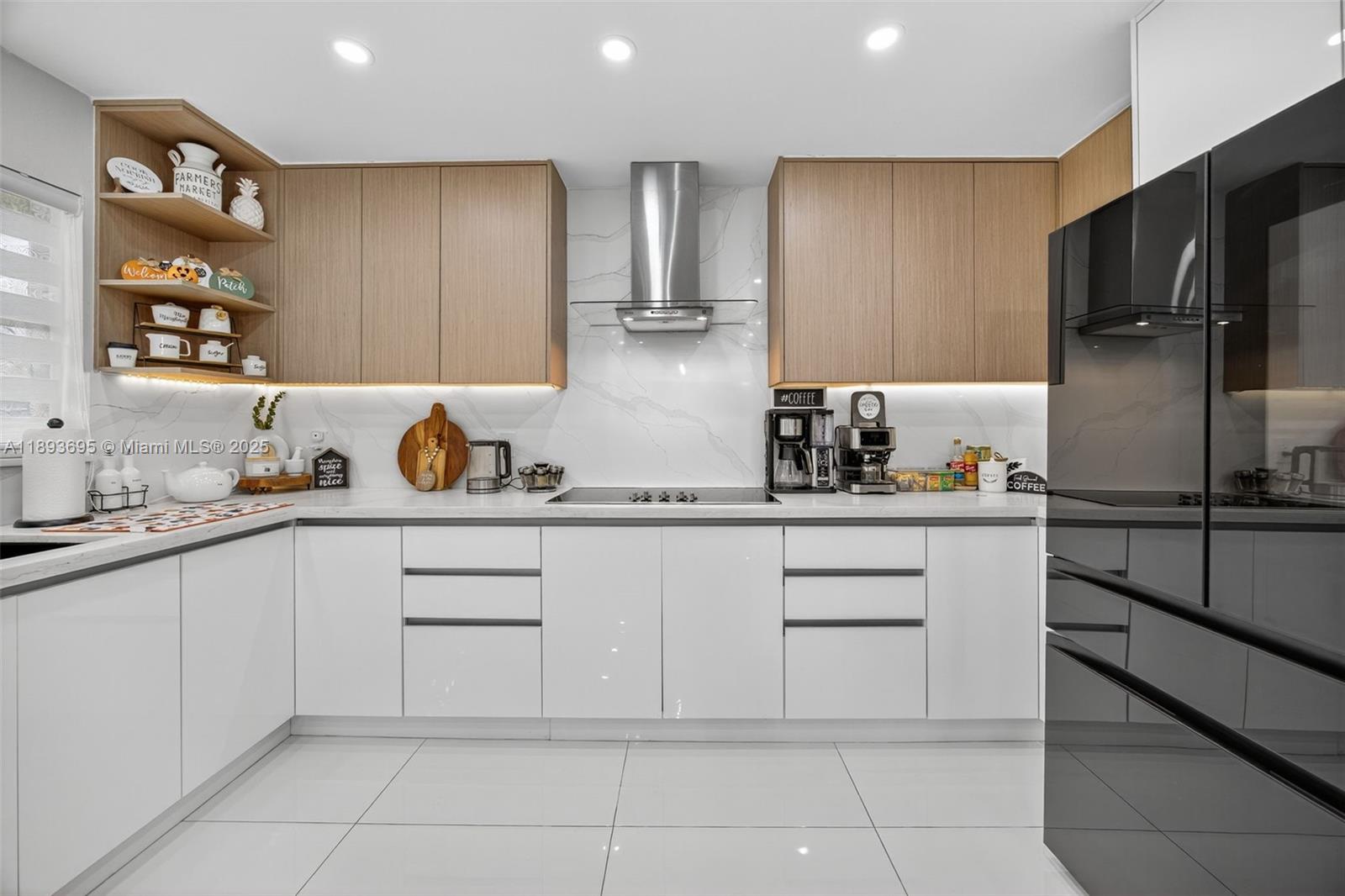 25796 Southwest 123rd Avenue Homestead, FL 33032 - Photo 7 of 26 a kitchen with a refrigerator and cabinets