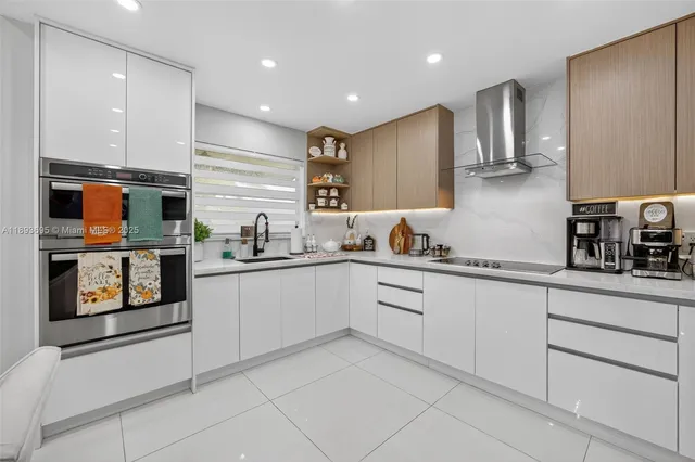 a kitchen with granite countertop cabinets stainless steel appliances a sink and a counter top space