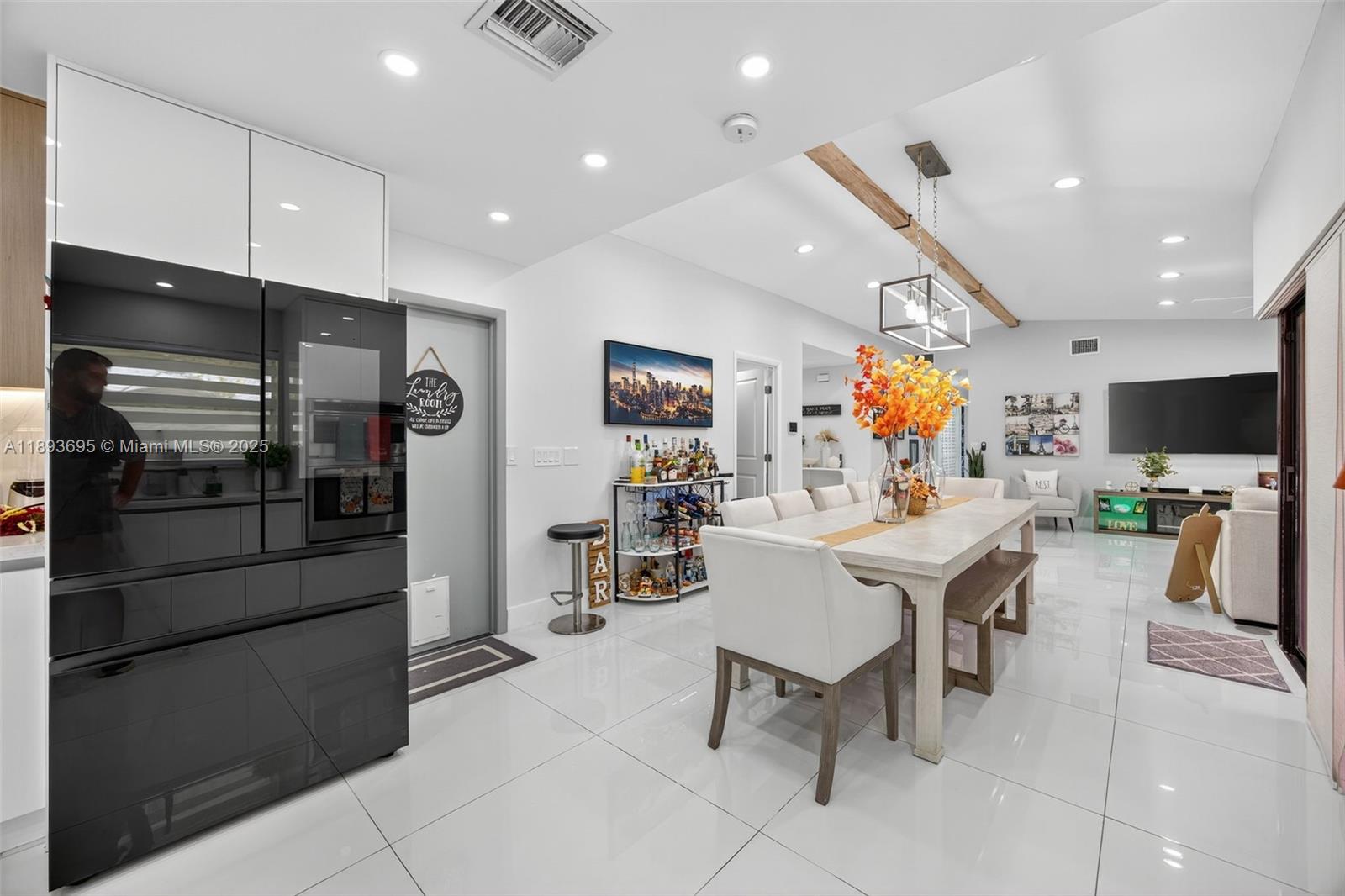 25796 Southwest 123rd Avenue Homestead, FL 33032 - Photo 9 of 26 a kitchen with stainless steel appliances kitchen island granite countertop a refrigerator and a sink