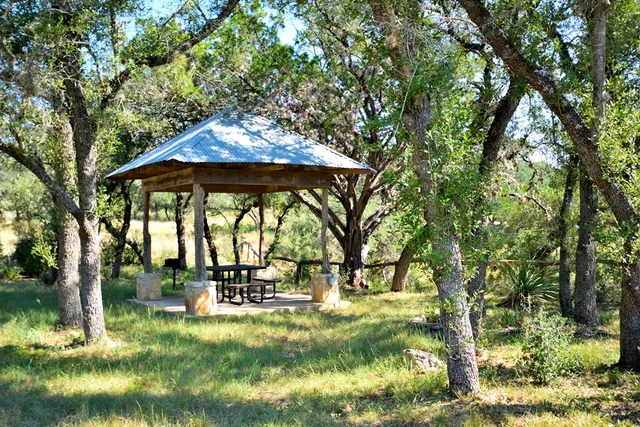 a view of a patio with a table chairs and a backyard