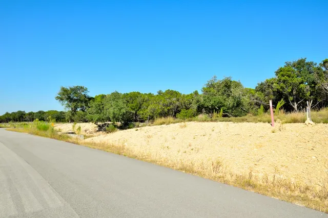 a view of yard with swimming pool and trees in the background