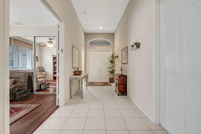 a view of a hallway with furniture and a livingroom view