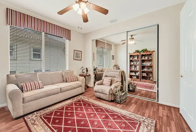 a living room with furniture and wooden floor