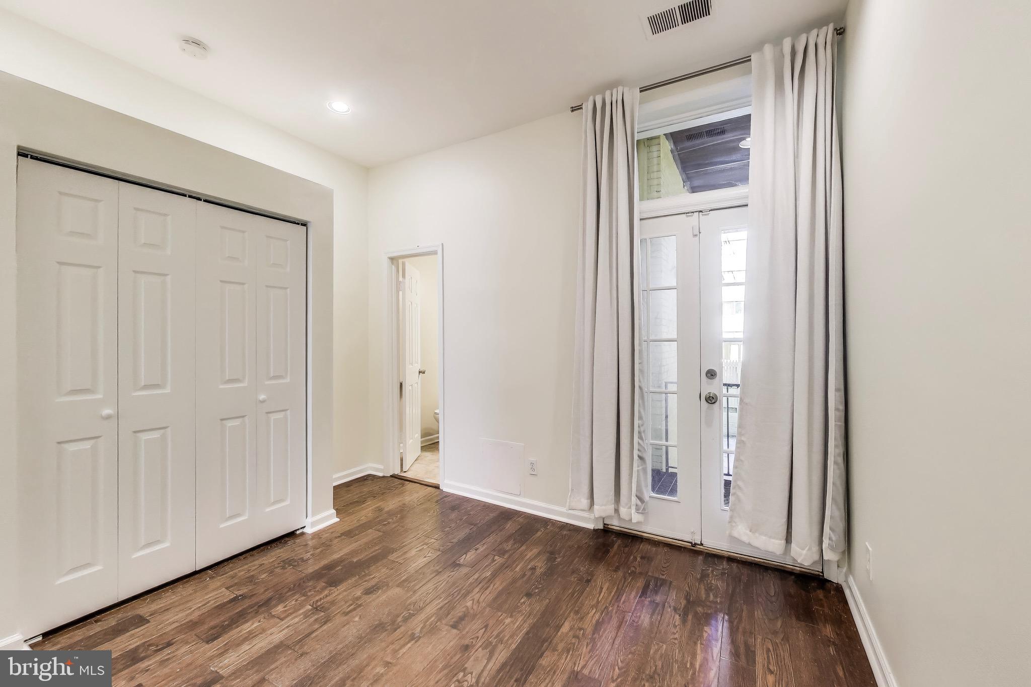 1625 S Street Northwest, Unit 1 Washington, DC 20009 - Photo 10 of 13 an empty room with wooden floor and closet area
