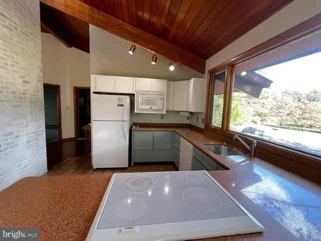 a view of a kitchen with a stove cabinets and a large window