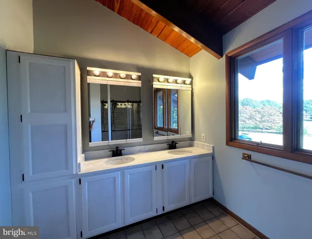 a bathroom with a glass shower door