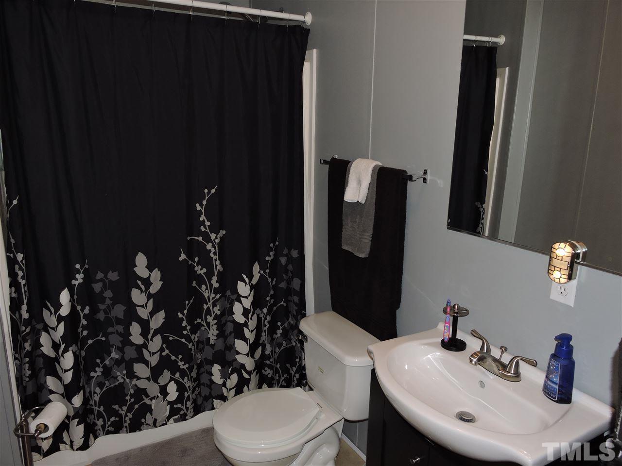 511 Christys Way Roxboro, NC 27574 - Photo 14 of 18 a bathroom with a sink toilet and mirror