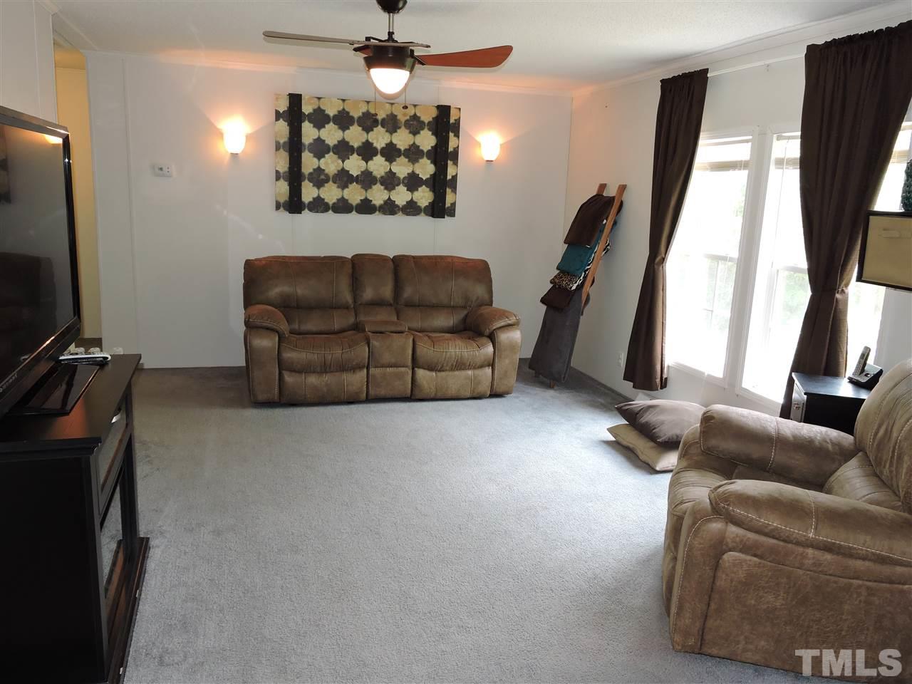511 Christys Way Roxboro, NC 27574 - Photo 4 of 18 a living room with furniture and a flat screen tv