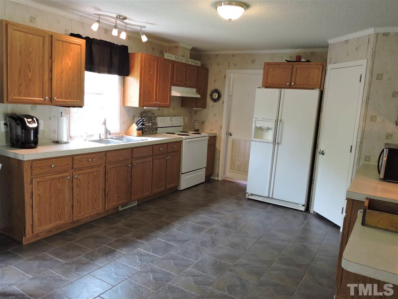511 Christys Way Roxboro, NC 27574 - Photo 6 of 18 a kitchen with a sink refrigerator and cabinets