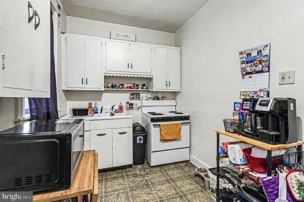 a kitchen with stainless steel appliances a stove a sink and a refrigerator