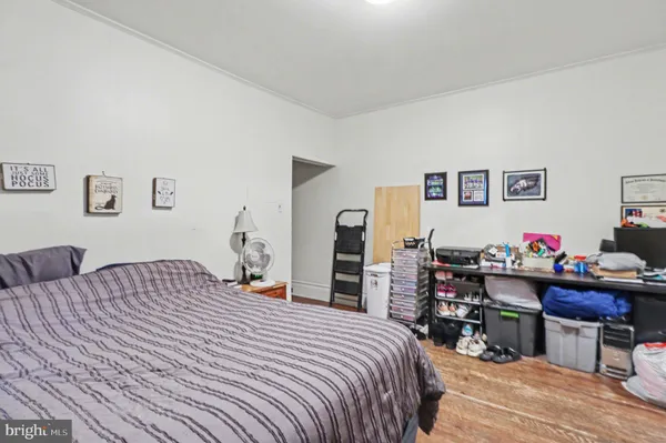 a bedroom that has a bed and a chair