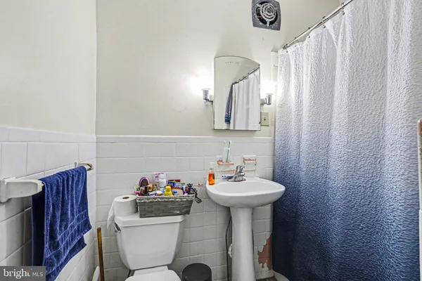 a bathroom with a sink mirror and toilet