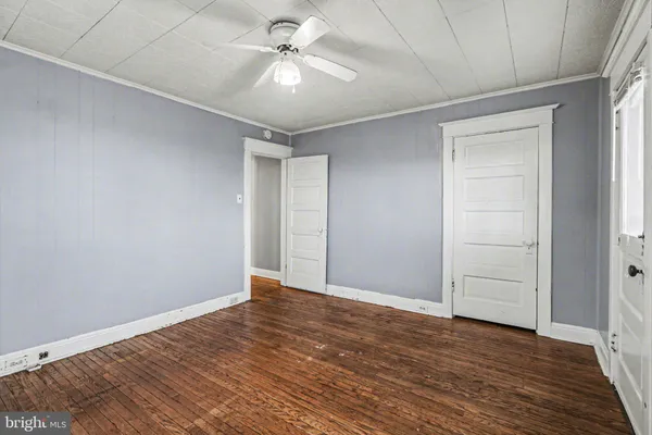 a view of an empty room with wooden floor