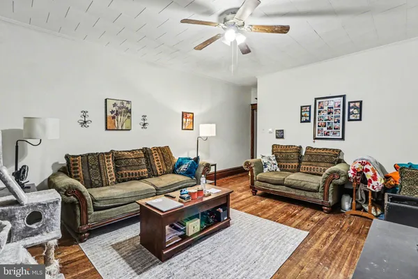 a living room with furniture a rug and a chandelier