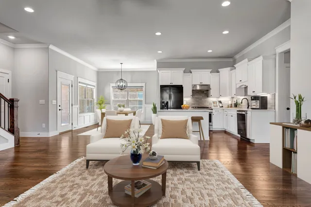a living room with furniture and kitchen view