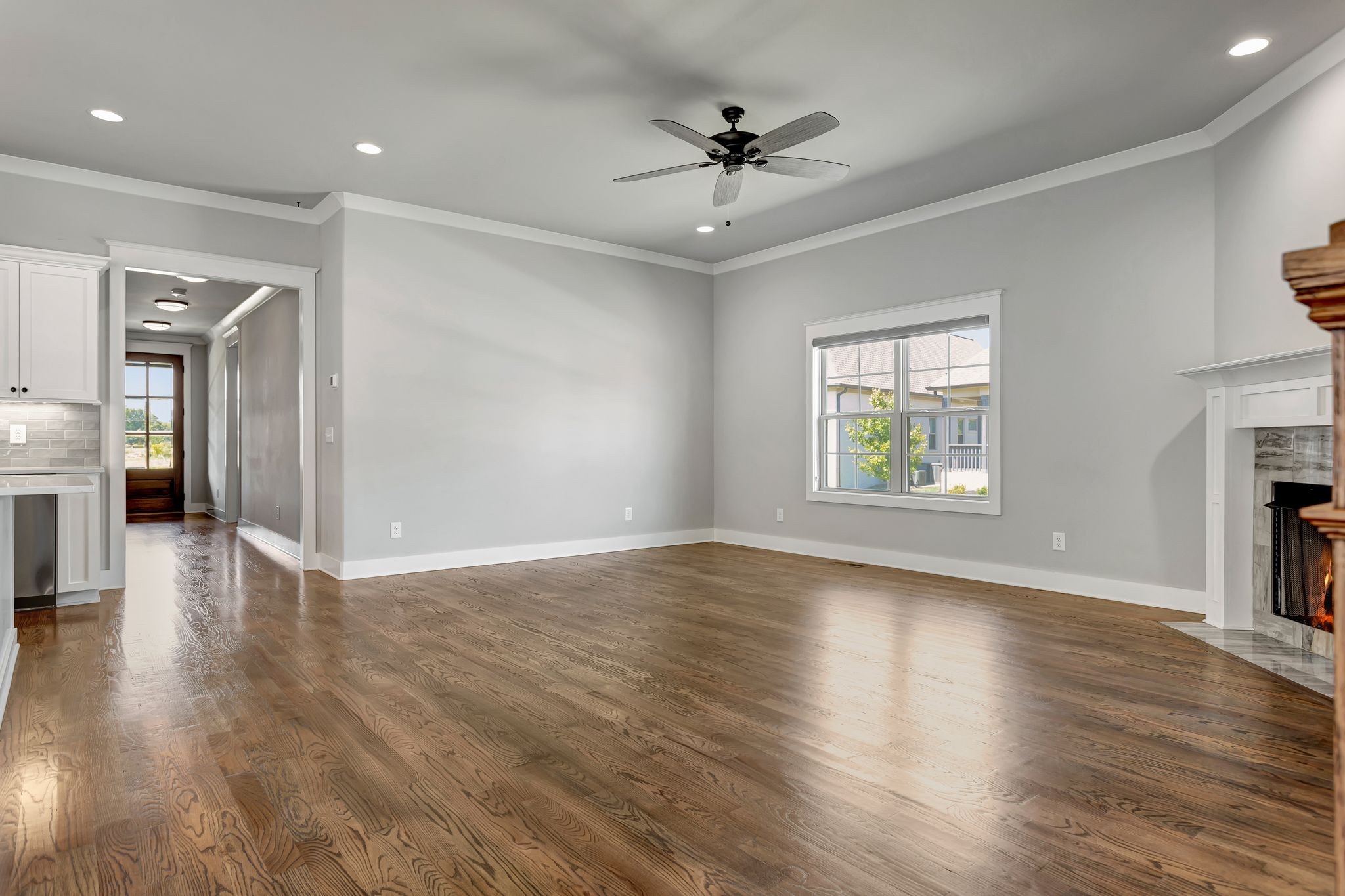 4050 Kiskadee Ln Spring Hill Spring Hill, TN 37174 - Photo 11 of 36 an empty space with wooden floor a ceiling fan and windows