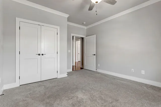 an empty room with a ceiling fan