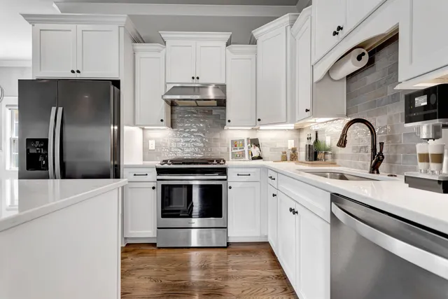 a kitchen with stainless steel appliances a sink stove and cabinets
