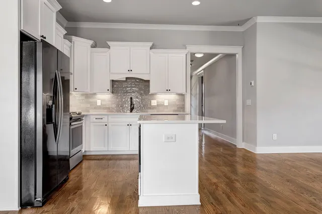 a kitchen with white cabinets and stainless steel appliances