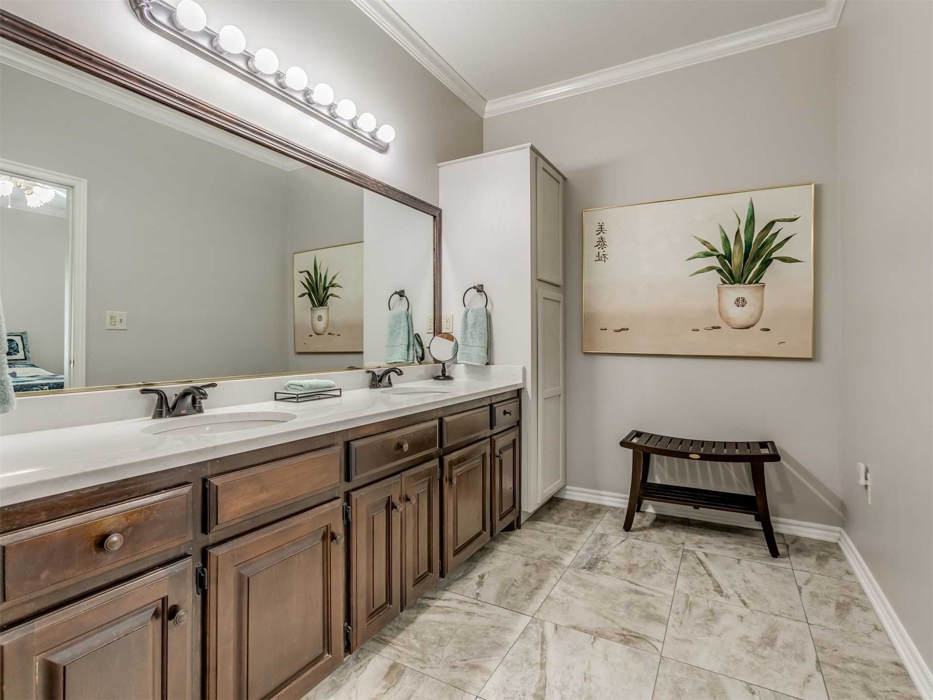 119 Mainsail Road Stigler, OK 74462 - Photo 27 of 52 Dual vanity with integrated sinks, dark wood-finish cabinetry, a white countertop, and extensive wall-mounted mirror