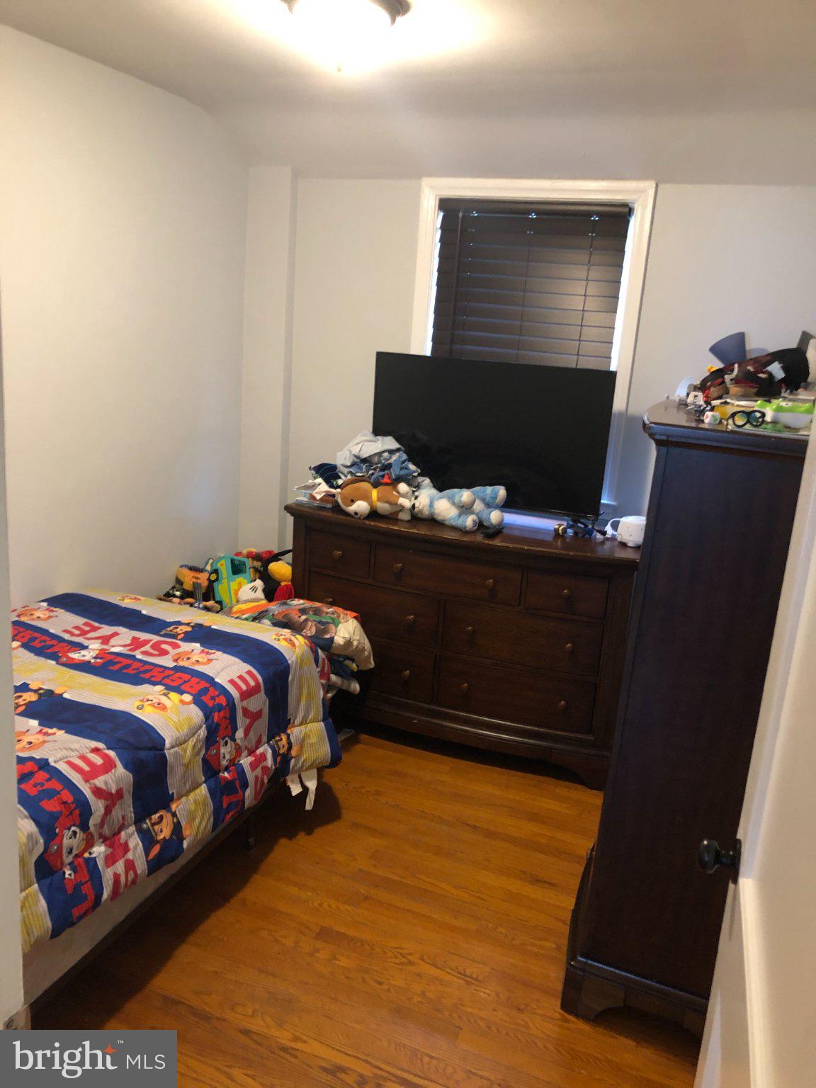 1658 Thetford Road Towson, MD 21286 - Photo 8 of 12 a bedroom with a bed and a flat screen tv