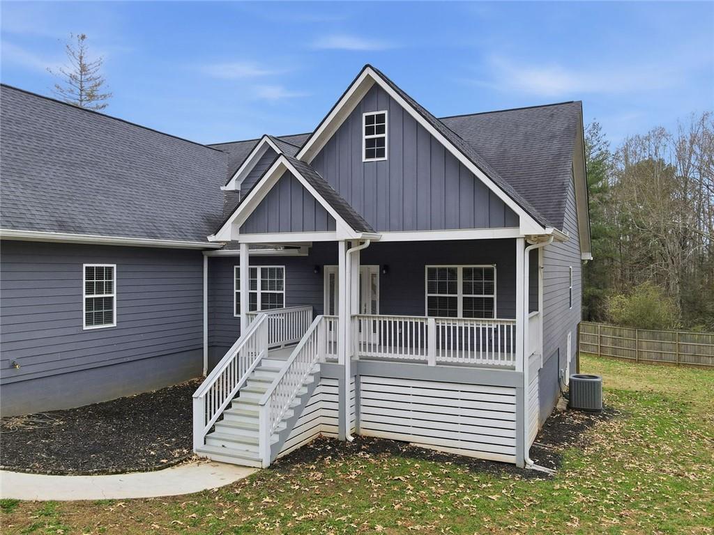 1006 Owens Store Road Canton, GA 30115 - Photo 3 of 48 a front view of a house with a yard