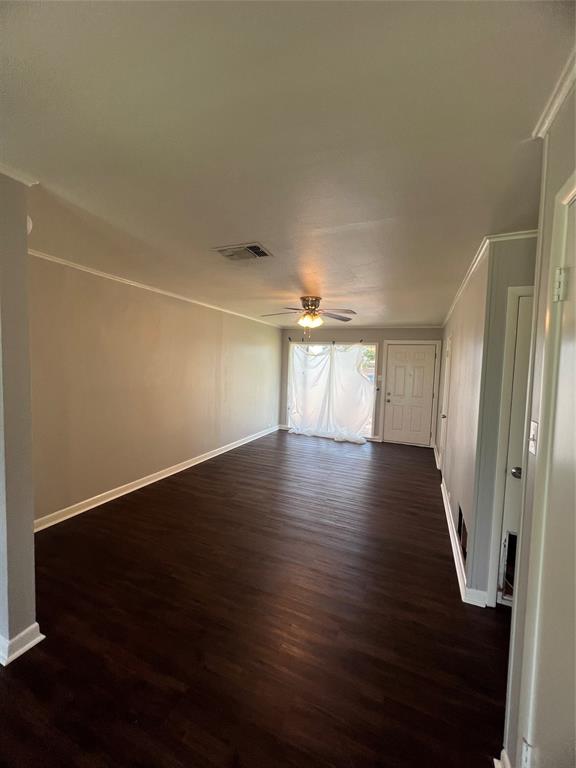 914 Huntington Lane Shreveport, LA 71106 - Photo 3 of 10 an empty room with wooden floor and windows