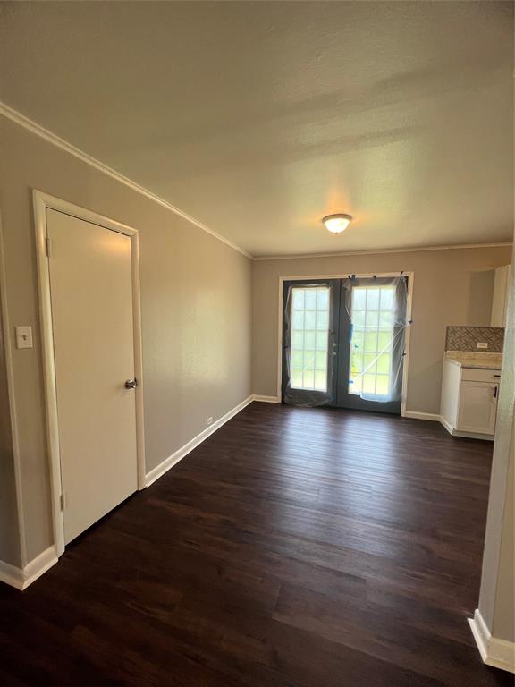 914 Huntington Lane Shreveport, LA 71106 - Photo 4 of 10 an empty room with wooden floor and windows