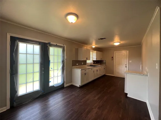 a view of kitchen with wooden floor and electronic appliances